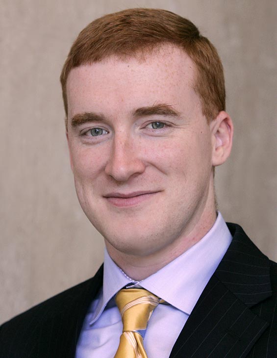 Professional headshot of Dr. Mueller in a suit and tie