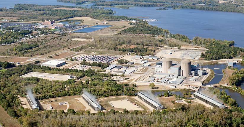 Prairie Island Nuclear Power Plant Aerial An aerial view of the Prairie Island Nuclear Power Plant, near Red Wing, Minnesota along the Mississippi River. The two pressurized water reactors produce approximately 1,100 megawatts. Shot from the open window of a small airplane. Four cooling tower units emit steam in the foreground. In the middle left is a secure area with multiple casks of nuclear waste. An Indian casino is in the background which makes for a good proximity comparison between a nuclear plant and a populated area. Nuclear Power Station Stock Photo