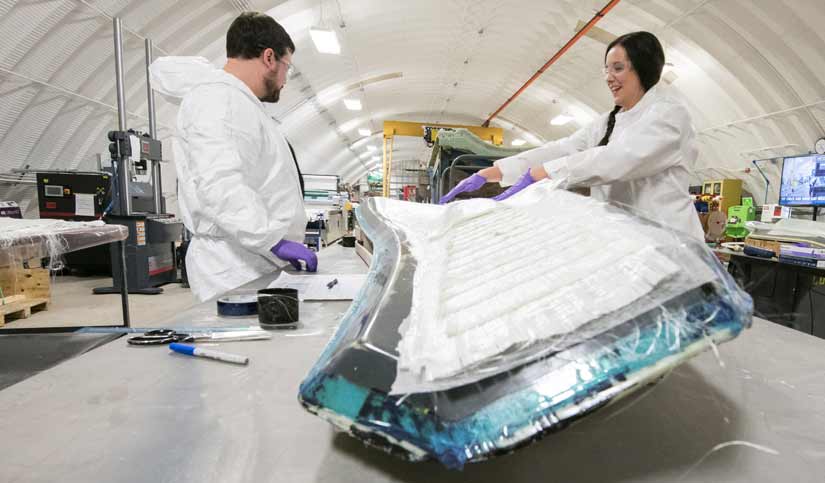 Researchers inside a campus building working on blade molds.