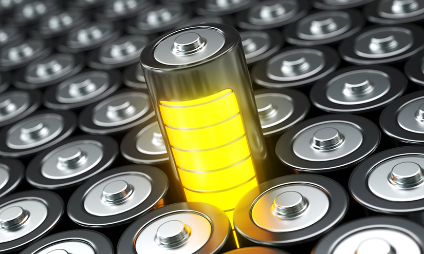 A yellow battery surrounded by other batteries.