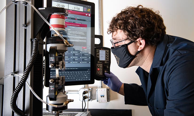 A man working with laboratory machinery.