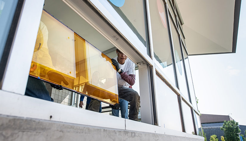 Men installing a window.