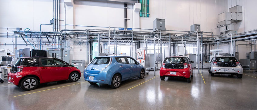 Four electric vehicles parked in an indoor facility.