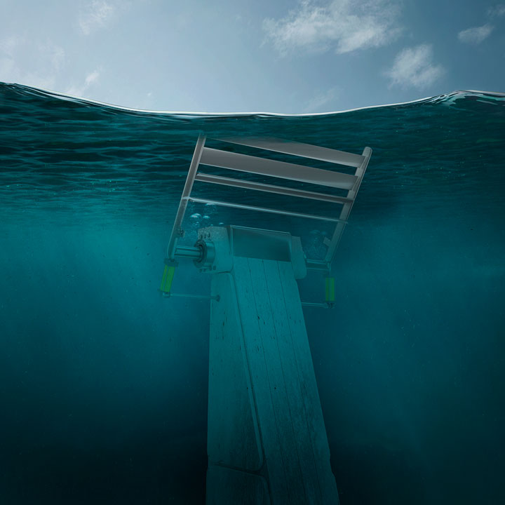 Image of a wave energy converter mounted on a cement, fixed-bottom foundation. Two power-take off units are on either side of the foundation, the top piece of the unit features adjustable louvers to increase energy capture and adjust to forces and loads.