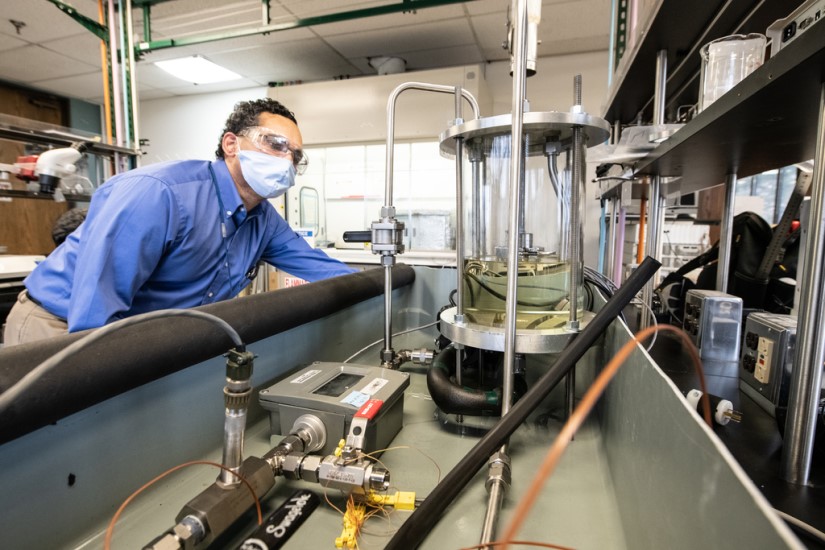 Image of a man operating lab equipment. 