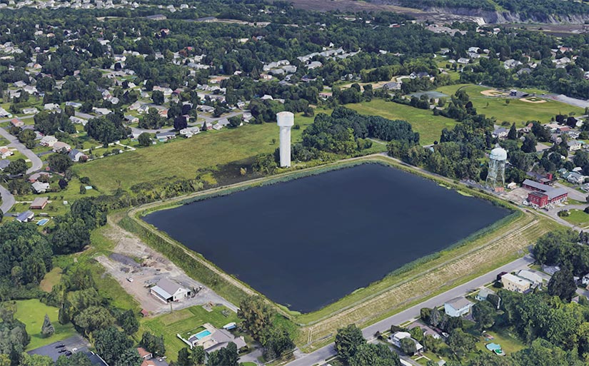 Aerial photo of a municipal water reservoir surrounded by houses