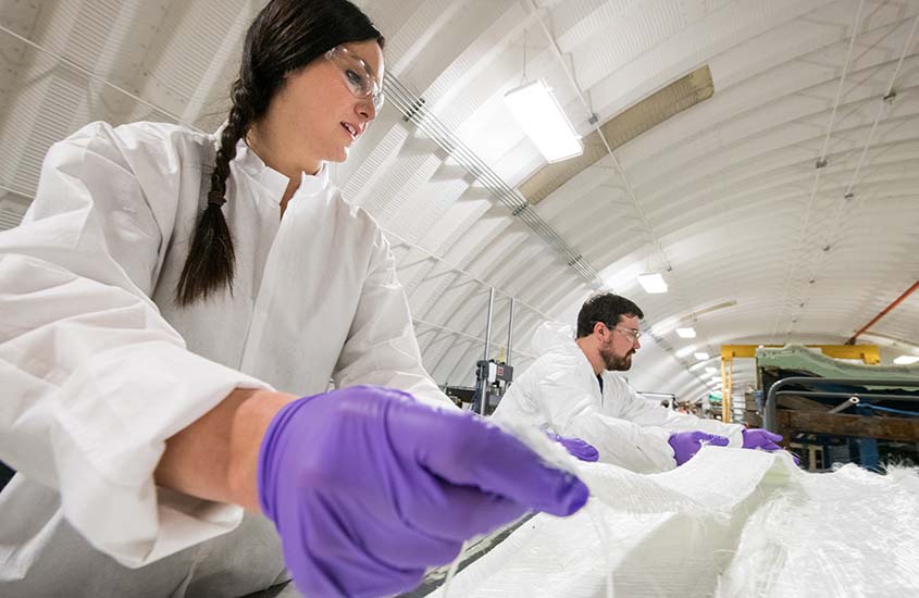 Two workers in a manufacturing facility