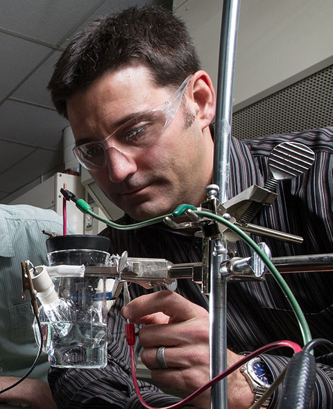 Photo of a man working with equipment in a lab