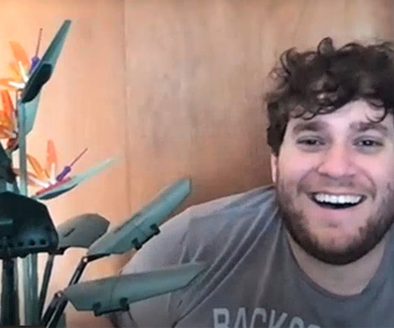 A screenshot of Nic Rorrer holding a plastic plant made of Legos