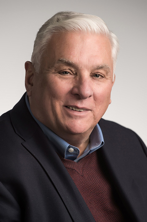 Headshot of a man in a suit