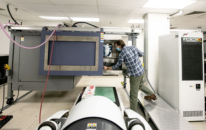A researcher working with large equipment in a lab.