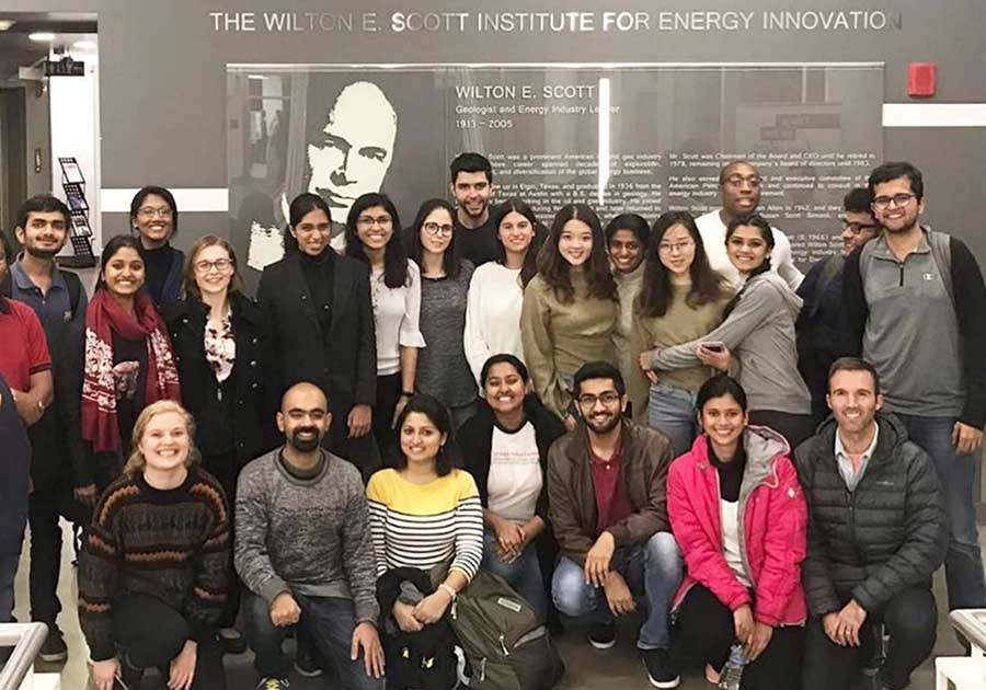 A large group of people posing in front of a sign that reads, "The Wilton E. Scott Institute for Energy Innovation."