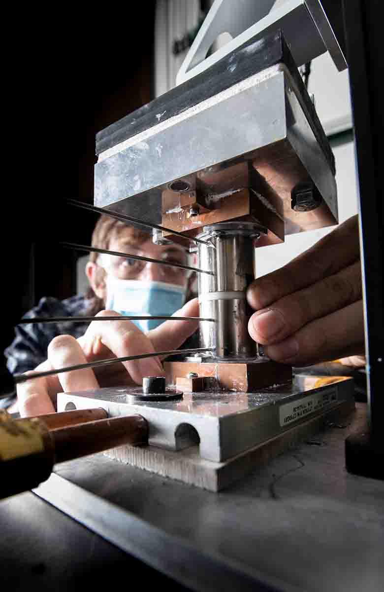 Researcher wears a mask to operate thermal test equipment