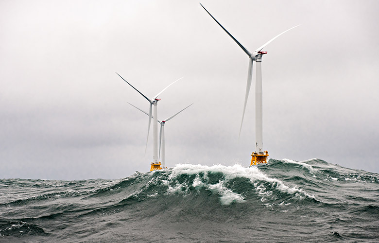 Wind turbines in a rough ocean.