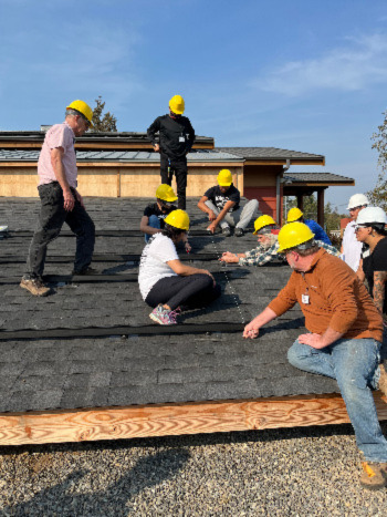 Community members are trained in the installation of solar PV on a mock roof at Northwest Indian College in Bellingham, Washington
