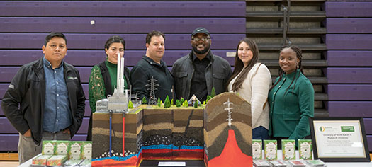 Six students pose with their geothermal model and their second-place certificate for the Geothermal Collegiate Competition.