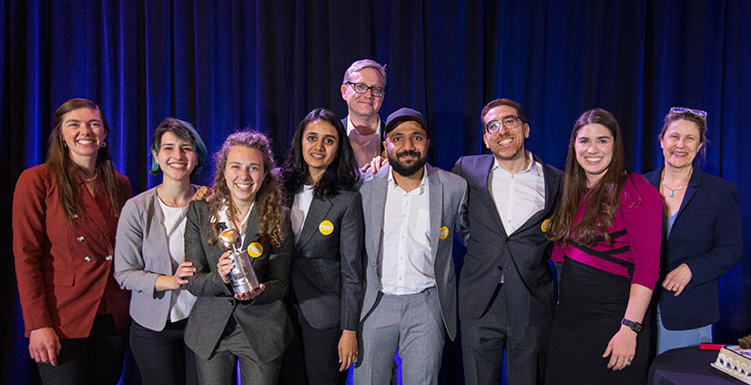 6 students from the Georgia Institute of Technology (Georgia Tech) pose on a stage with three organizers of the Solar Decathlon.