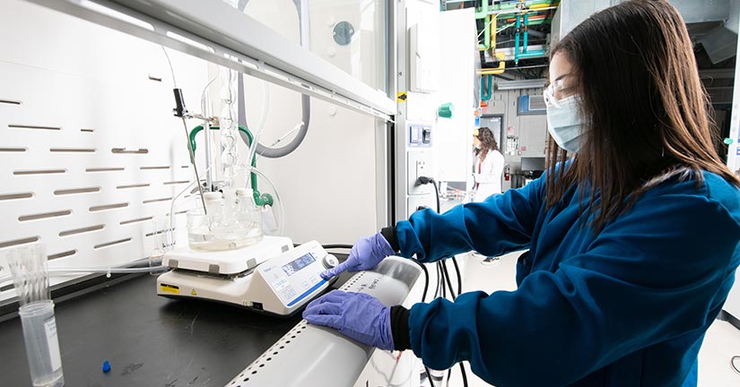 A researcher working with lab equipment.