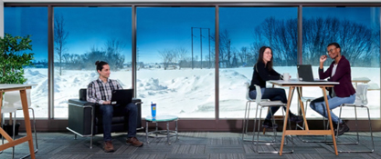 Image of people inside a sunny room with tinted windows.> Image from SageGlass