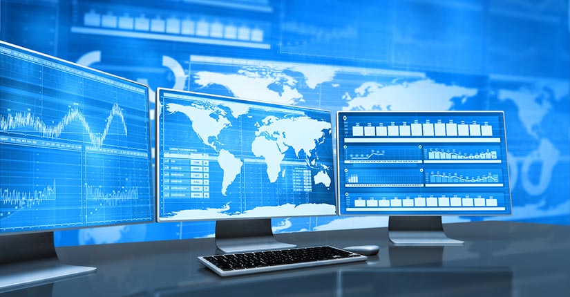 Digital image of computer monitors displaying global data with the data on large screens behind the monitors. NREL and USAID have developed the Resilient Energy Platform to improve cybersecurity globally for the electrical grid.