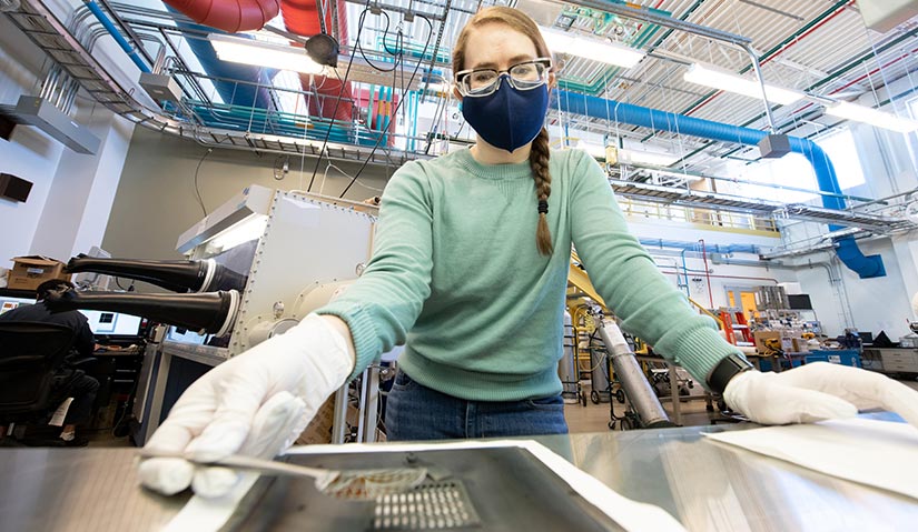 A woman in a lab working with equipment.