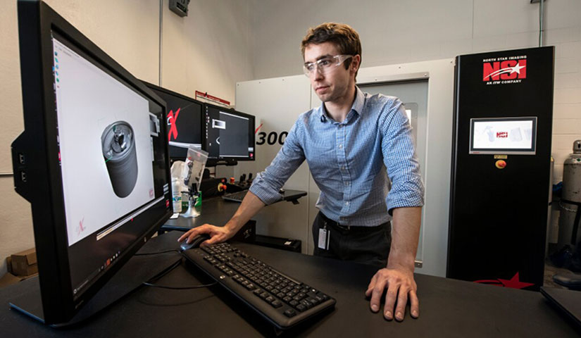 A researcher working at a desktop computer.