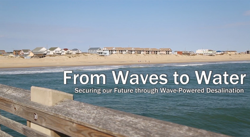 A beach lined with houses with the words From Waves to Water: Securing Our Future Through Wave-Powered Desalination overlain.
