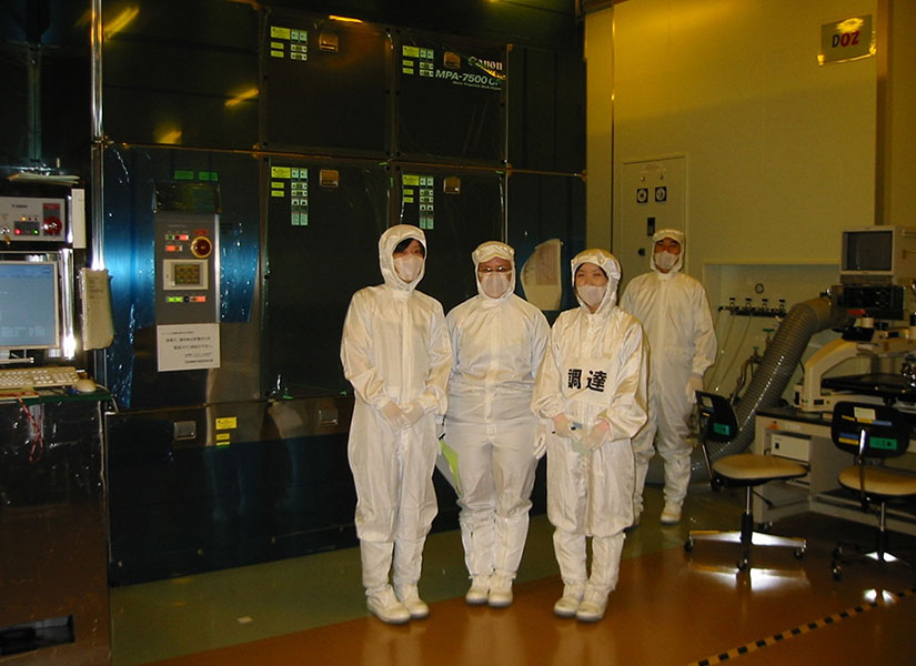 Three people in masks and head-to-toe personal protective gear posing for the camera.