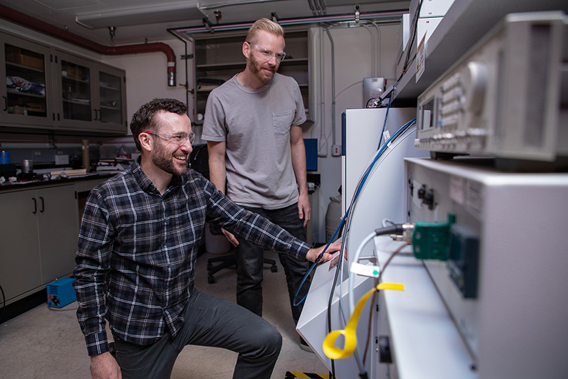 Two people work in a lab. 