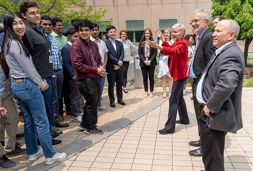 A group of students talk with Secretary Granholm.