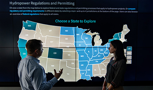 Two people in front of an interactive U.S. map