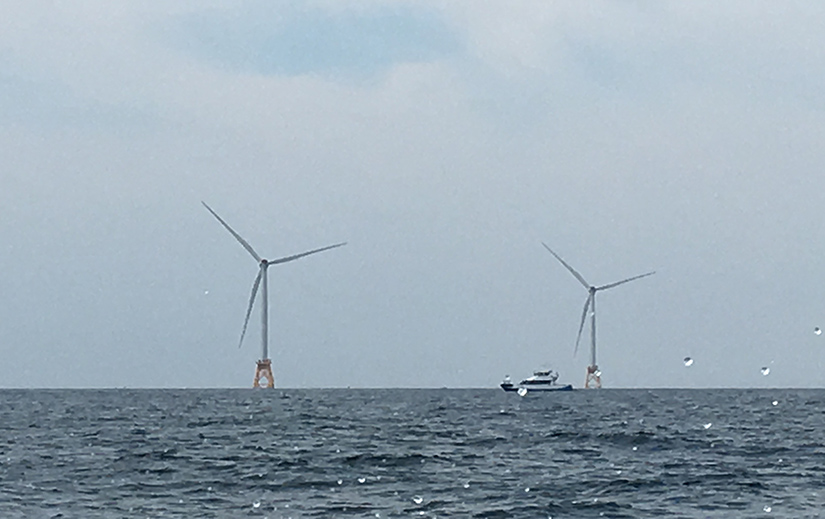 Photo shows wind turbines off the coast of Rhode Island.