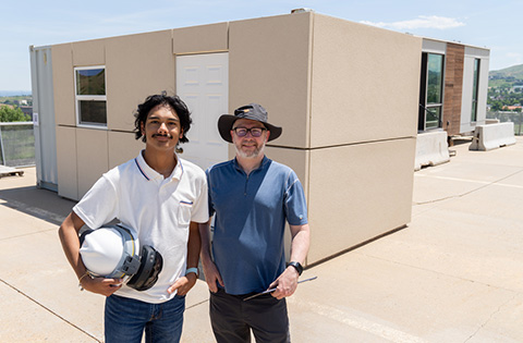 Summer 2023 JUMP into STEM intern Zachary Trahan and his mentor David Goldwasser stand together on the roof of a building on NREL's campus.
