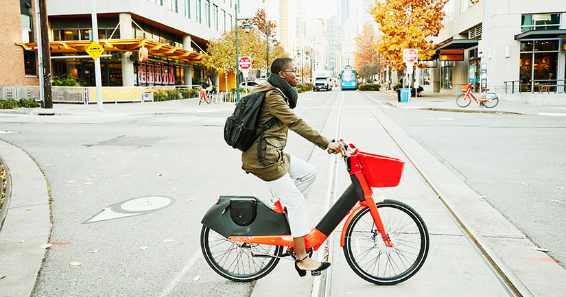 An electric bike sitting in front of a moving train.