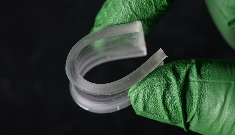 Two fingers bending a rubbery polymer