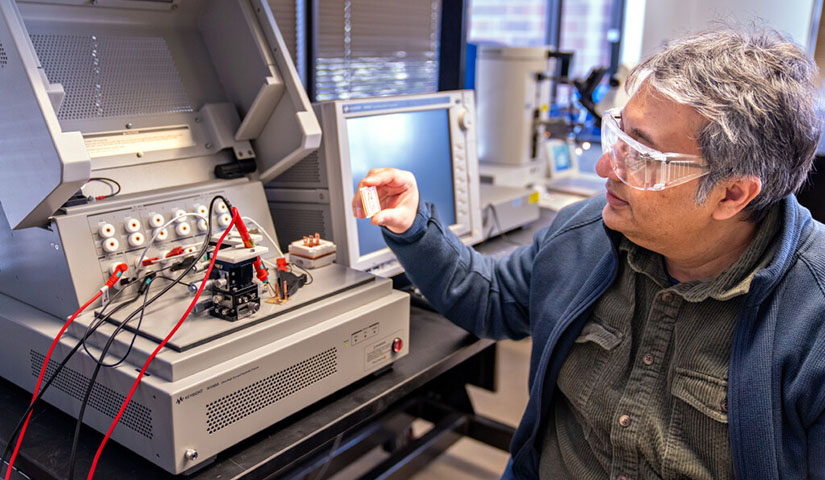 Faisal Khan holds a small wireless controller for a power module. 