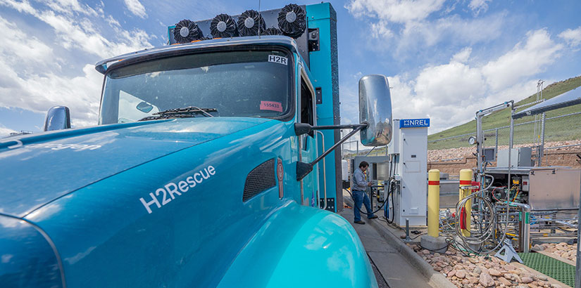 The H2Rescue vehicle has the text “H2Rescue” printed on top of the front fender and above the wheel well. The vehicle is parked in front of NREL’s hydrogen fueling station.