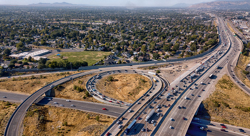 A sweeping drone view from above of the busy streets and i-80 freeway around Salt Lake City.