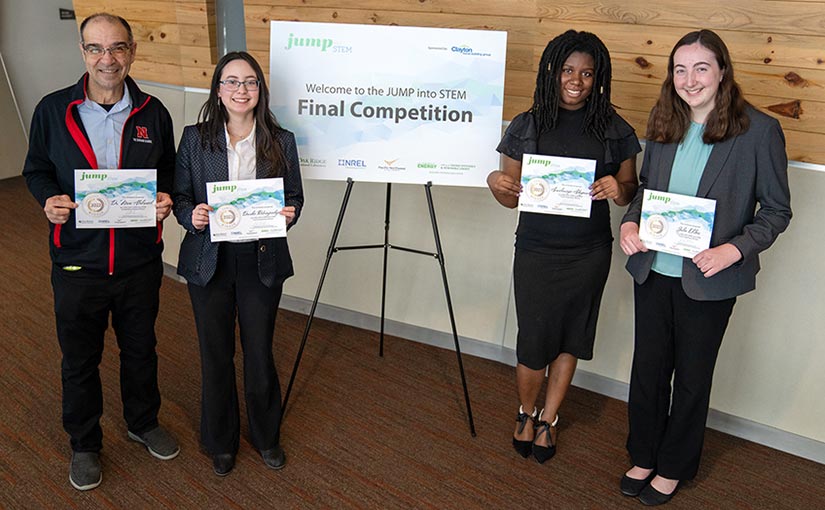 Four researchers holding certificates.