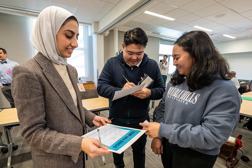 Three people looking at paper.