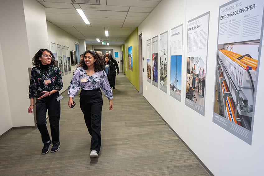 Two students walking down a hall.