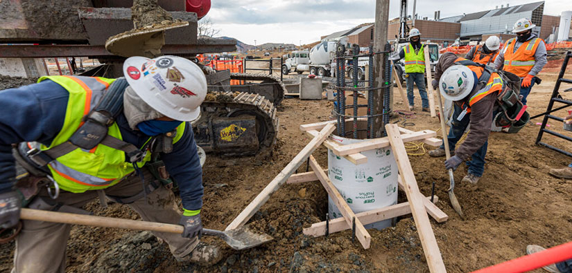 Construction crew preparing to pour a concrete pillar.