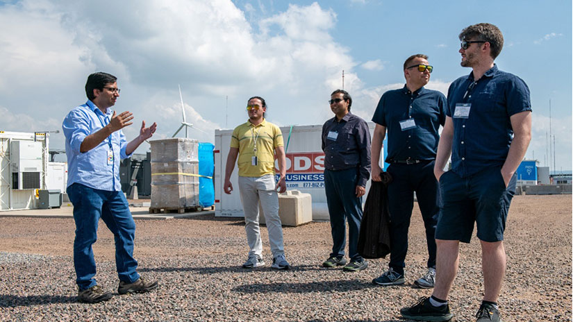 Mayank and Dany standing outside with their colleagues.