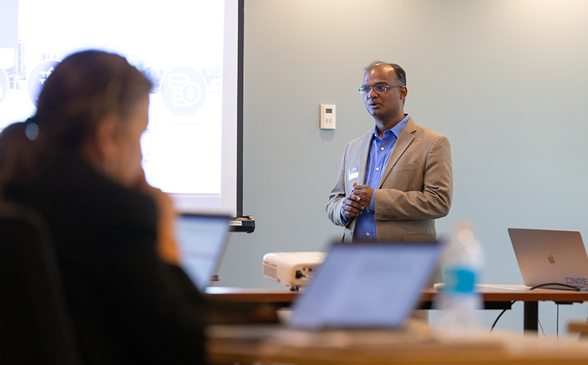 A man speaking to a room.