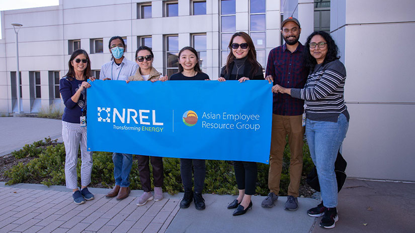 Seven people holding a banner that reads “Asian Employee Resource Group”