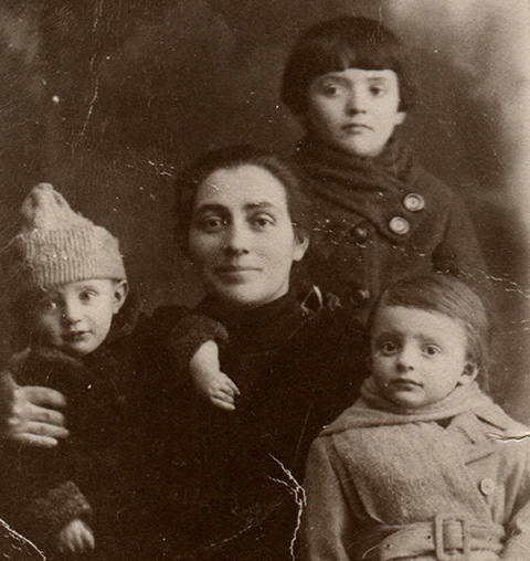 An old black and white portrait of a woman with three children