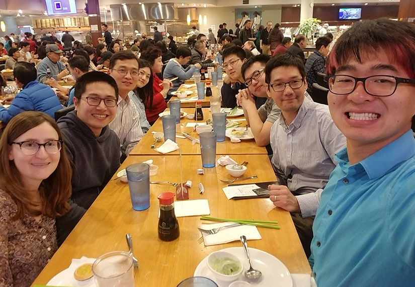 A group of people sitting at a dining table in a restaurant.