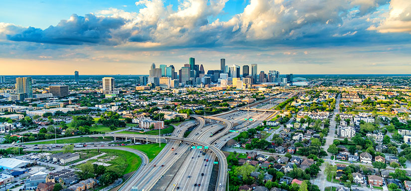 An aerial image of a cityscape and major roadway system.