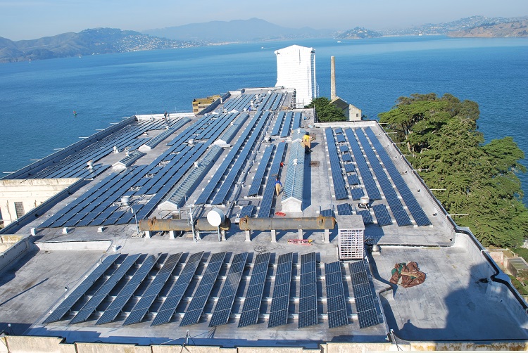 Aerial view of a large building with PV panels on the rooftop.