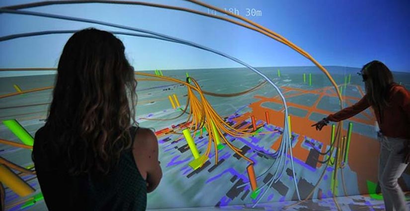 Two researchers evaluate a 3D visualization of an energy system.